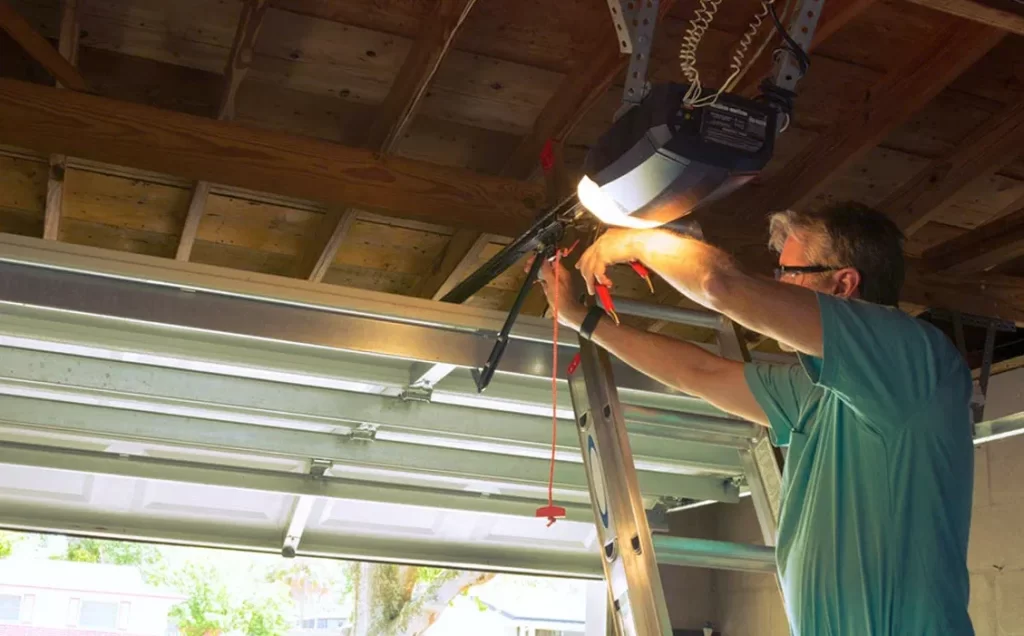 Technician repairing a residential garage door opener system