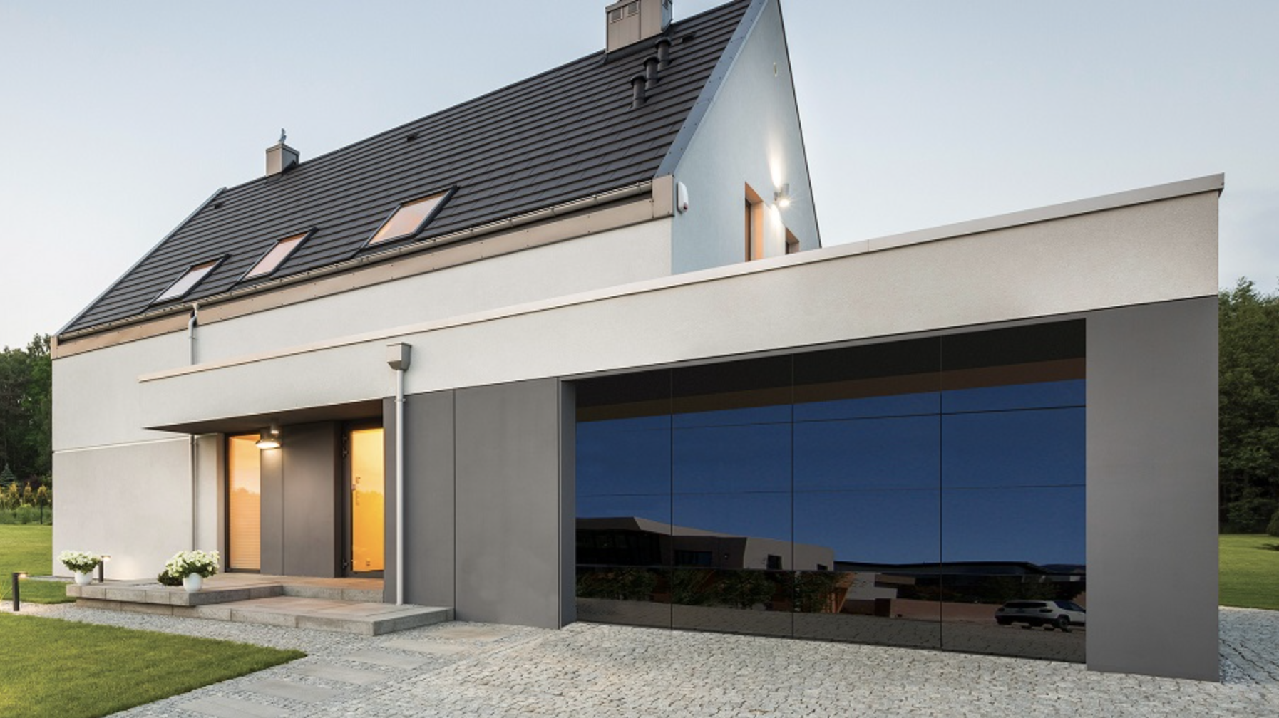 Modern two-story house with large windows and garage entryway
