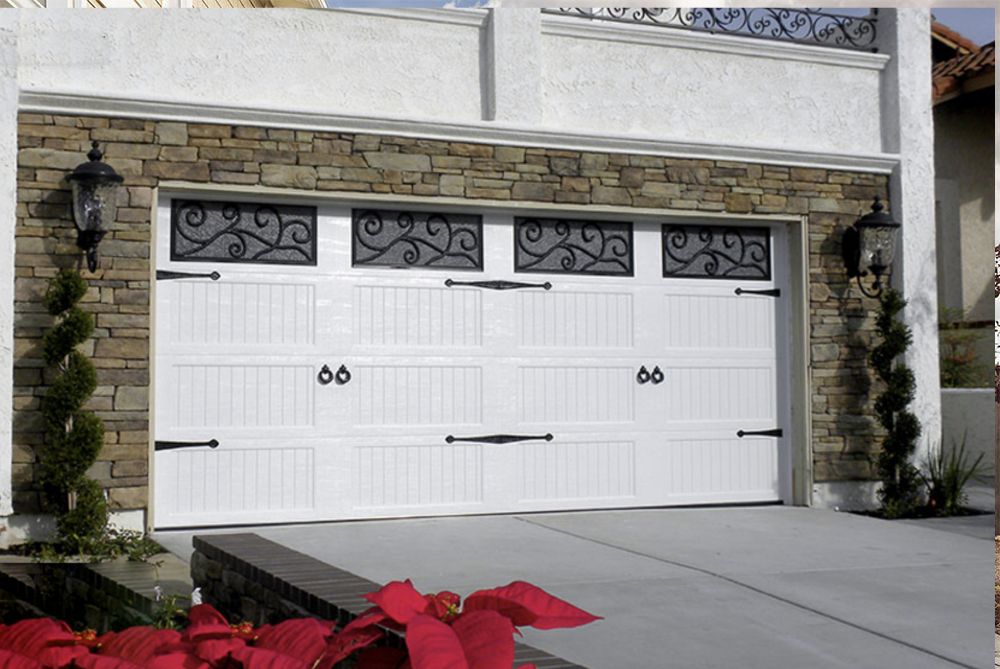 White garage door with decorative windows and stone accents